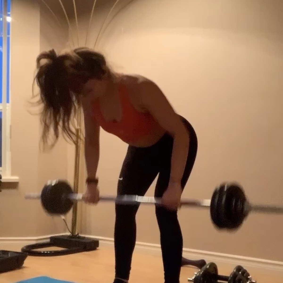 Wendy mid Romanian deadlift with a barbell
